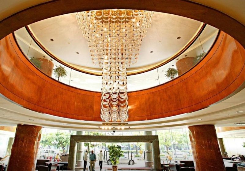 Evergreen Laurel Hotel - Taichung Luaran gambar The photo shows the interior of a lobby, featuring a large, elegant chandelier hanging from a circular ceiling. The design incorporates warm wooden tones and modern architectural elements. The space is open and airy, with large glass windows allowing